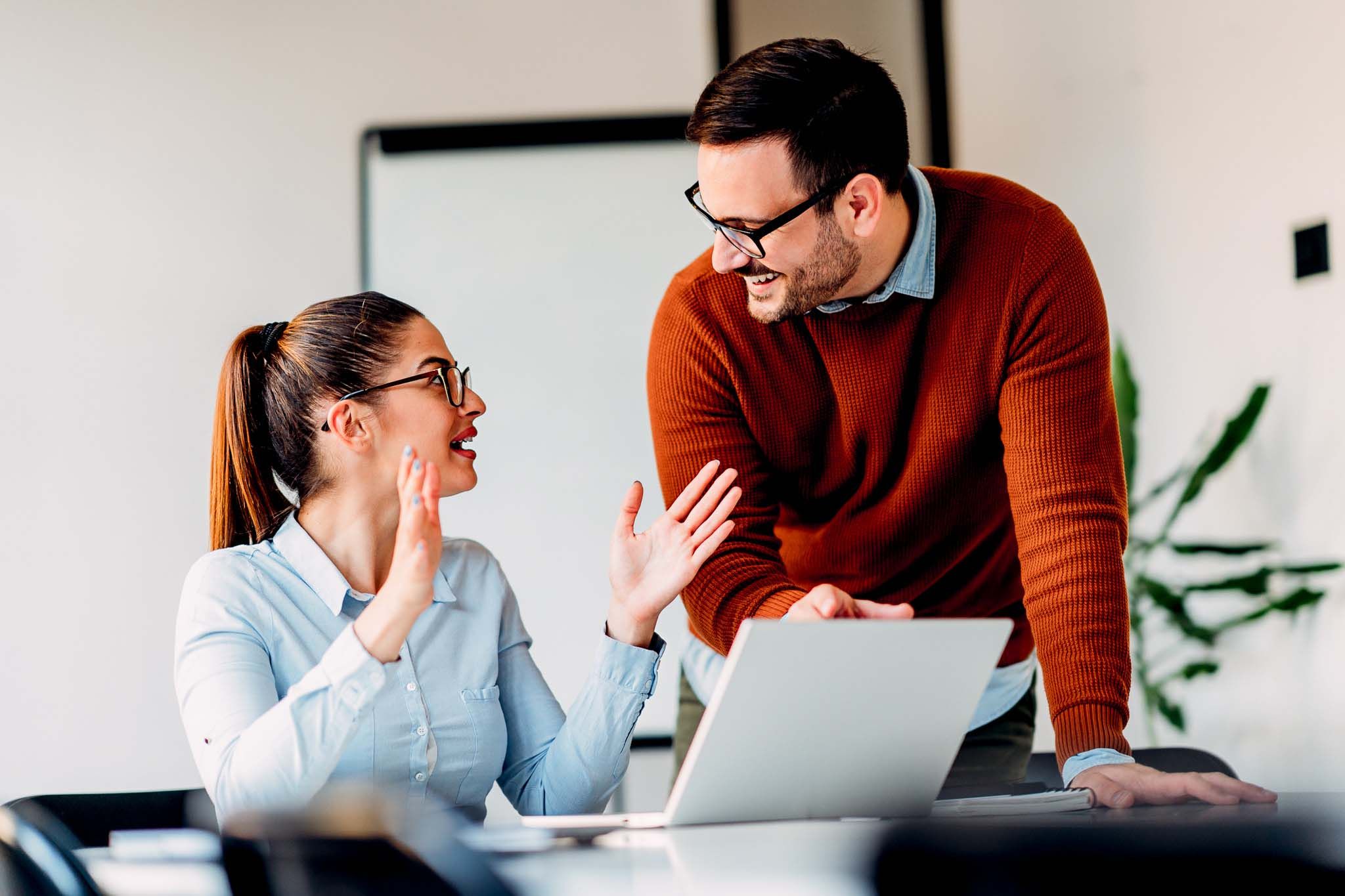 Young female employee consulting with manager